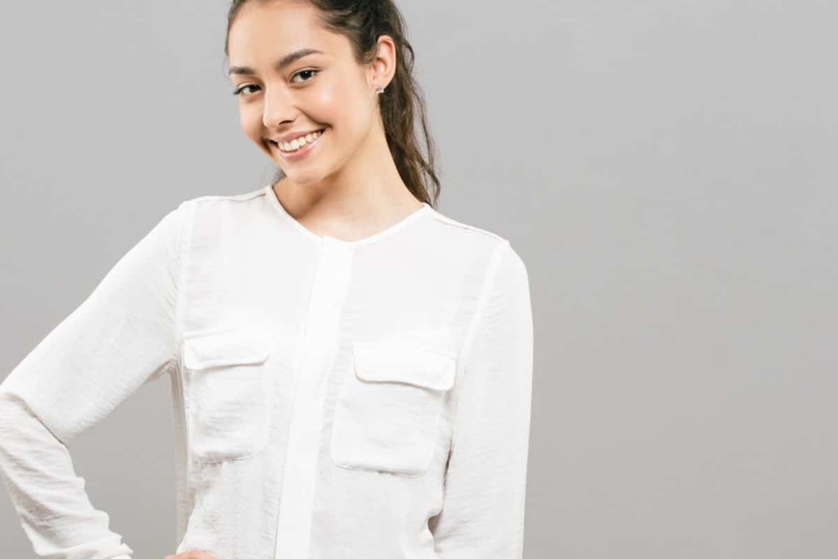 A smiling person showcasing healthy teeth, symbolizing the connection between dental and mental health.